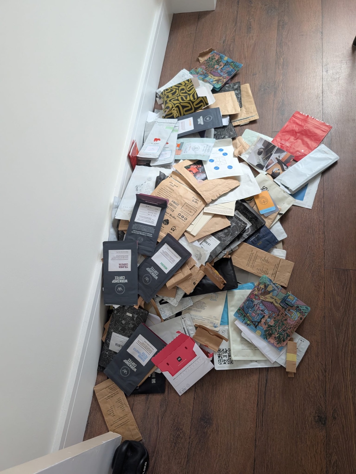 A pile of emptied coffee bags on the floor